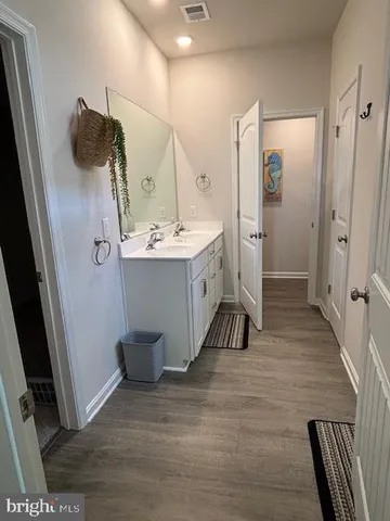 a bathroom with a sink and mirror