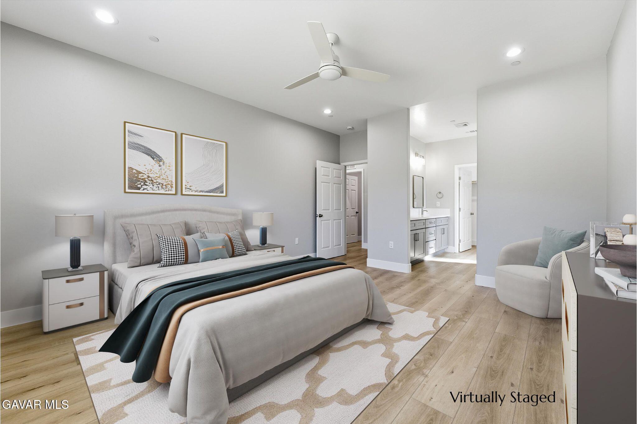 22613 Royal Place Tehachapi, CA 93561 - Photo 17 of 28 a spacious bedroom with a bed and a couch