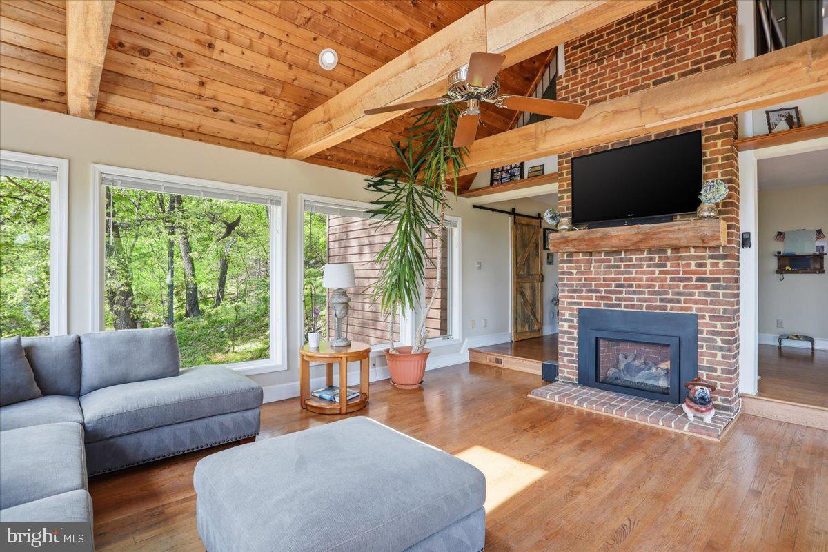 19897 Foresthill Road Bluemont, VA 20135 - Photo 14 of 39 a living room with furniture a flat screen tv and a fireplace