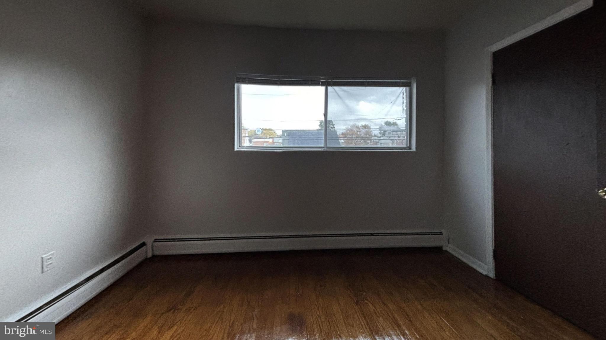 1606 Rhawn Street, Unit 4 Philadelphia, PA 19111 - Photo 3 of 4 a view of a room with wooden floor and a window