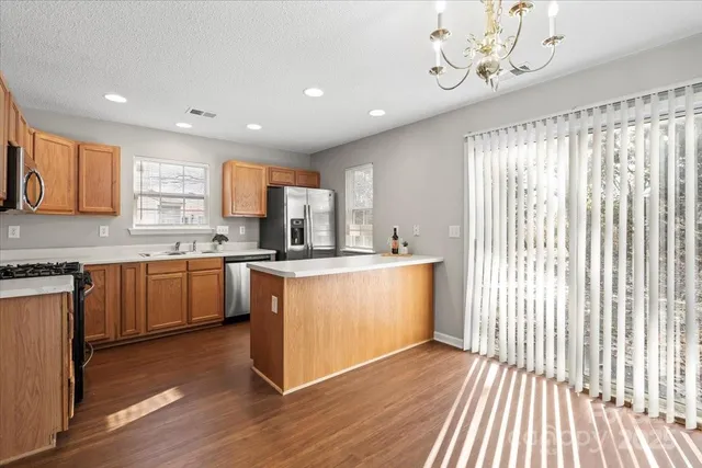 a kitchen with a sink window and cabinets