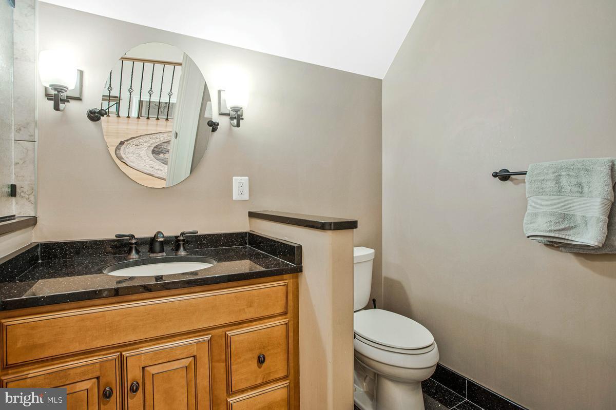 5 Jessie Road Harwood, MD 20776 - Photo 54 of 87 a bathroom with a granite countertop toilet sink and mirror