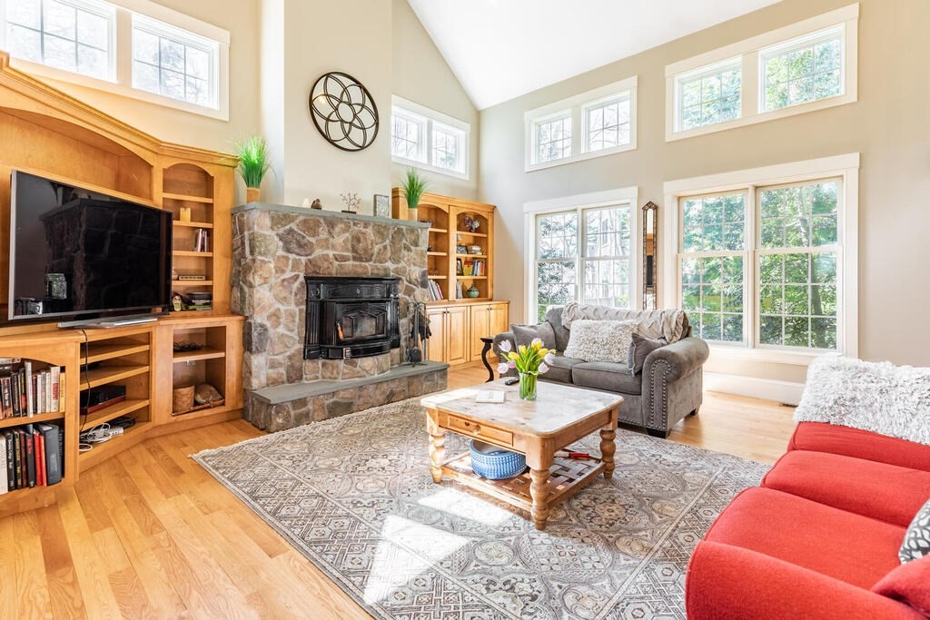 101 Clarke Circle Needham, MA 02492 - Photo 12 of 31 a living room with furniture a flat screen tv and a fireplace