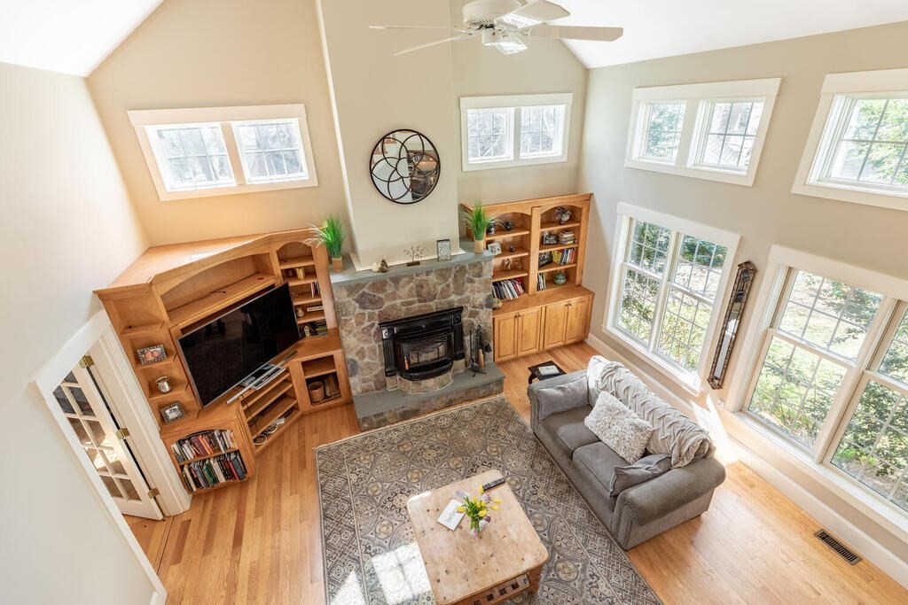 101 Clarke Circle Needham, MA 02492 - Photo 14 of 31 a living room with furniture a flat screen tv and a fireplace