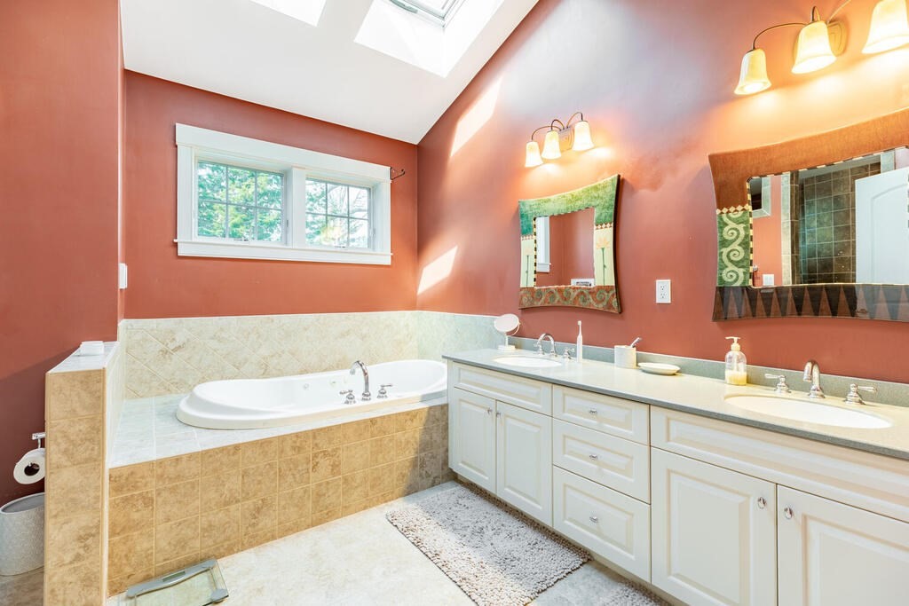 101 Clarke Circle Needham, MA 02492 - Photo 22 of 31 a bathroom with a double vanity sink mirror and bathtub