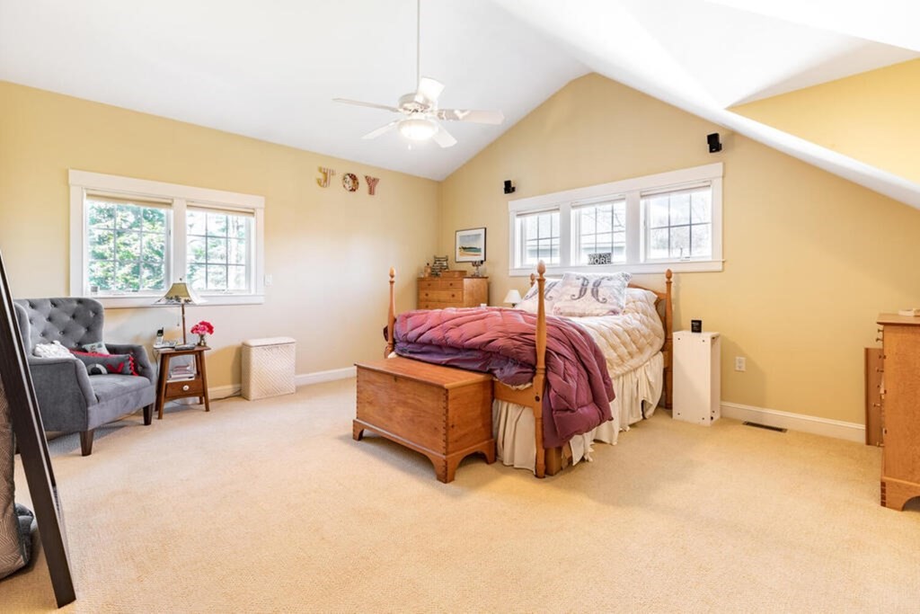101 Clarke Circle Needham, MA 02492 - Photo 23 of 31 a spacious bedroom with a bed and a couch