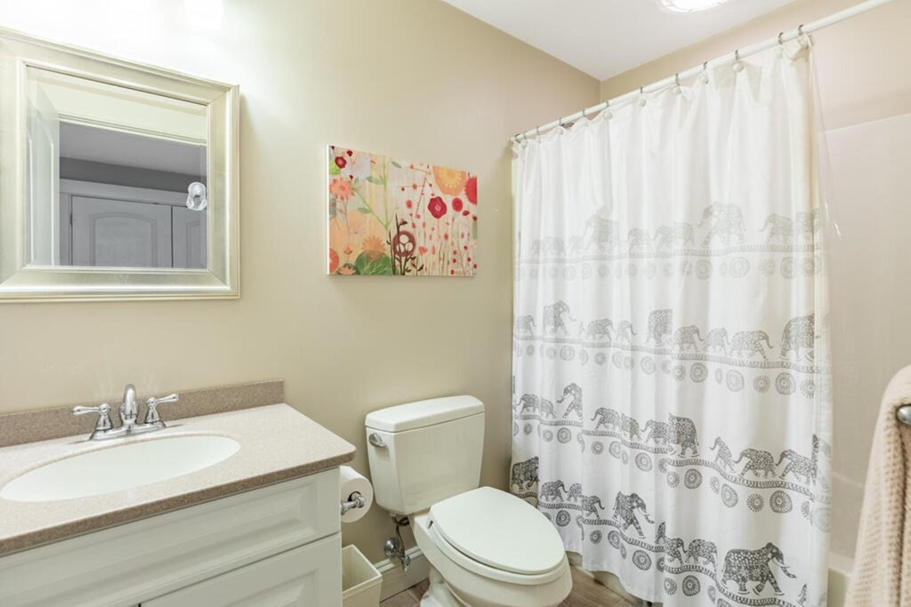 101 Clarke Circle Needham, MA 02492 - Photo 24 of 31 a white toilet sitting next to a bathroom sink