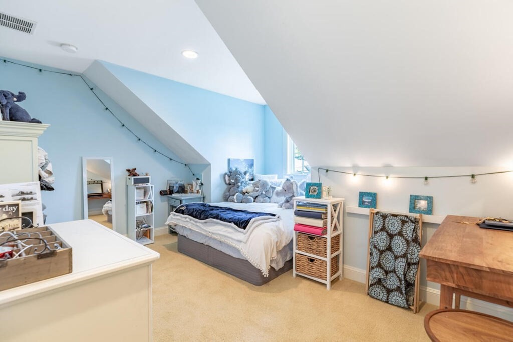 101 Clarke Circle Needham, MA 02492 - Photo 25 of 31 a living room with furniture and a chandelier