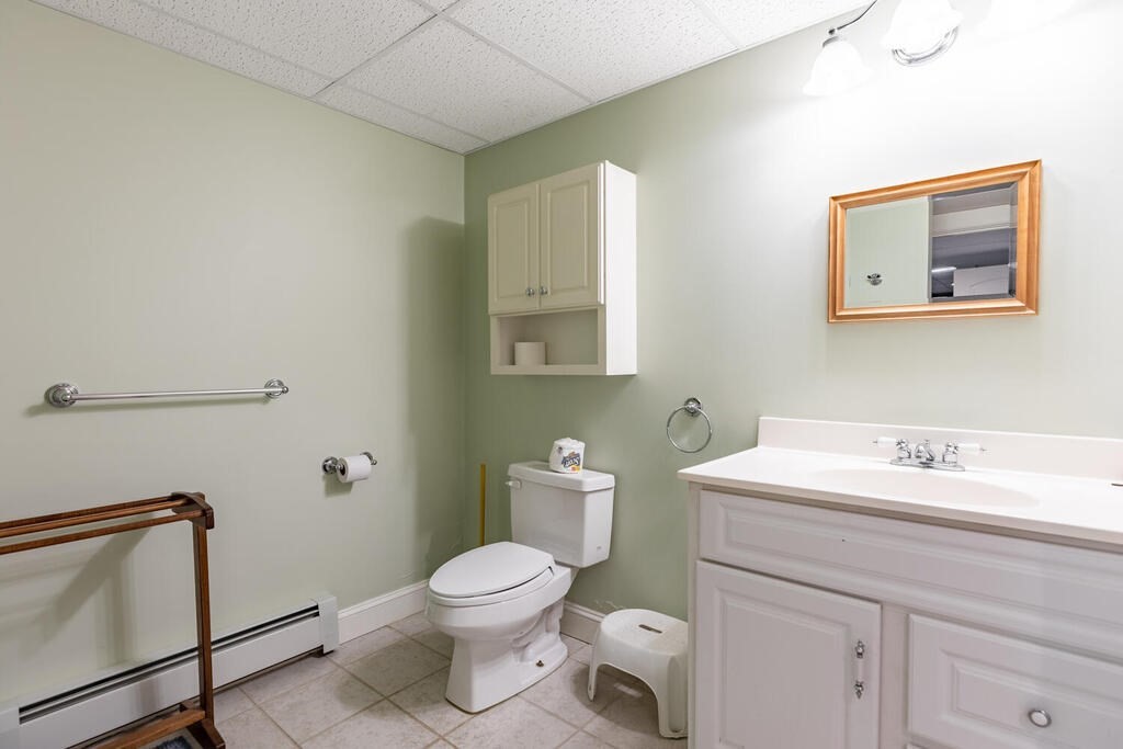 101 Clarke Circle Needham, MA 02492 - Photo 29 of 31 a bathroom with a toilet sink and mirror