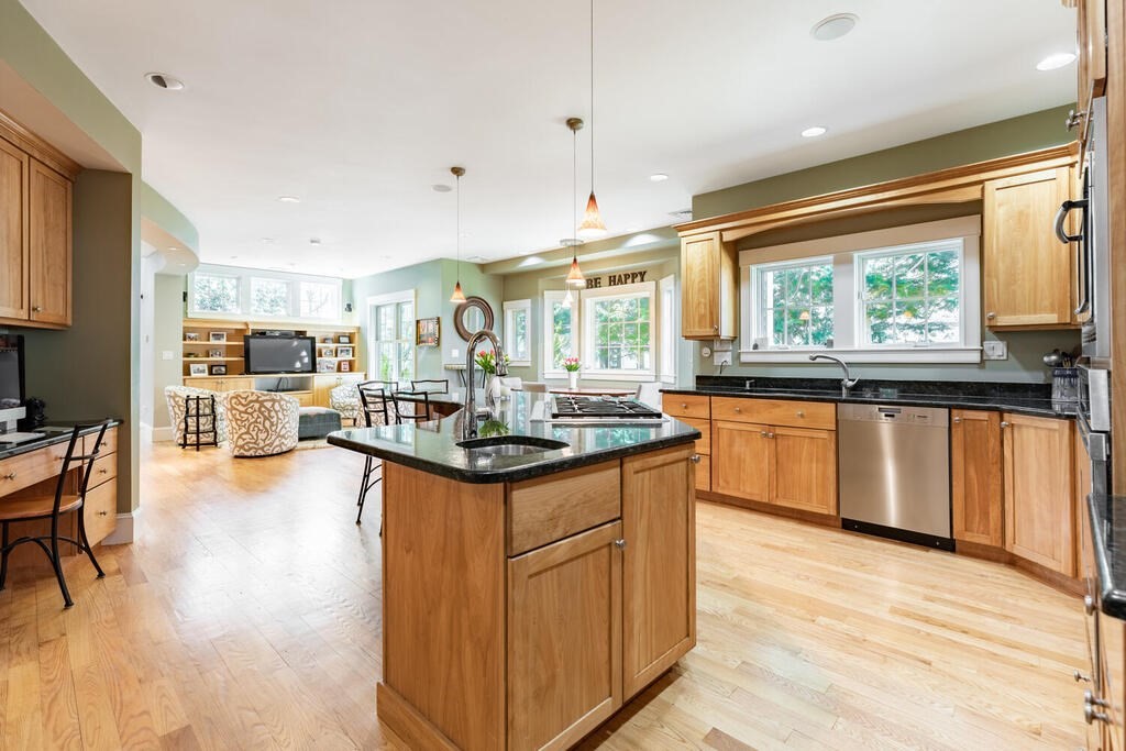 101 Clarke Circle Needham, MA 02492 - Photo 5 of 31 a kitchen with stainless steel appliances granite countertop sink stove top oven and cabinets