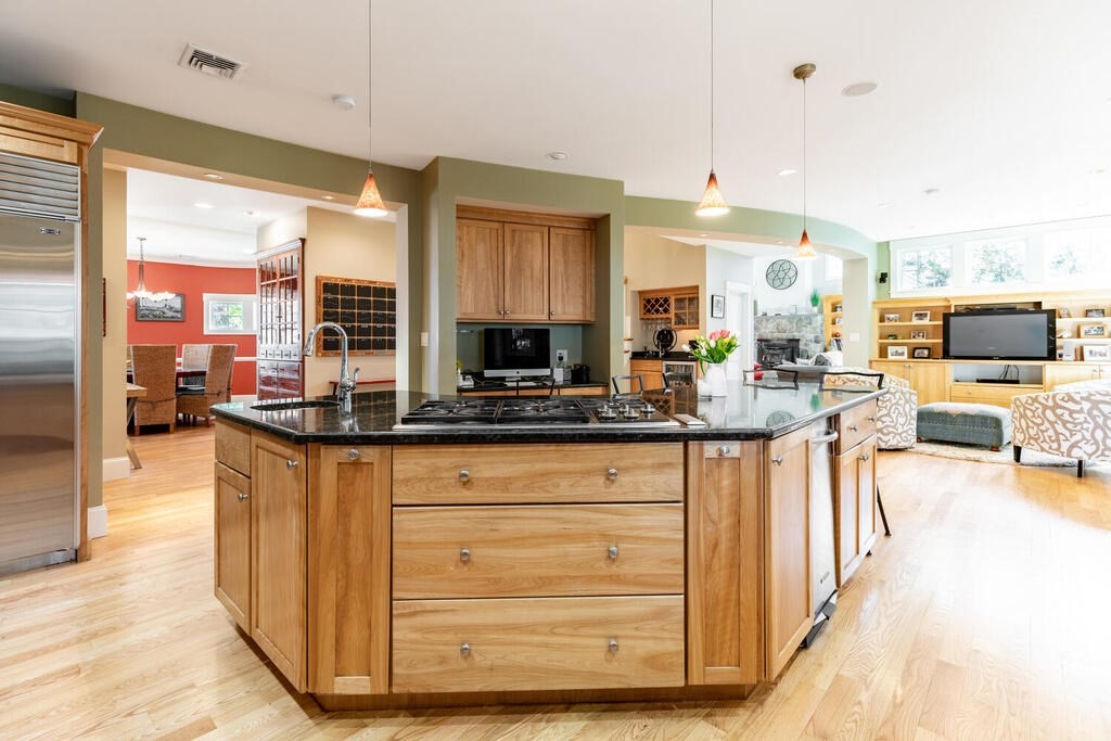 101 Clarke Circle Needham, MA 02492 - Photo 6 of 31 a kitchen with stainless steel appliances granite countertop a stove and cabinets
