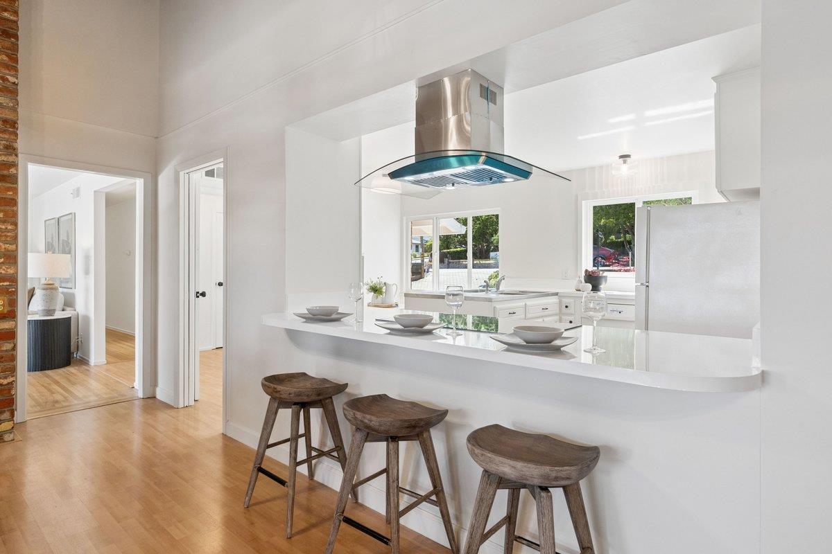 622 Terrace Road San Carlos, CA 94070 - Photo 31 of 83 a kitchen with stainless steel appliances kitchen island a large window and chairs
