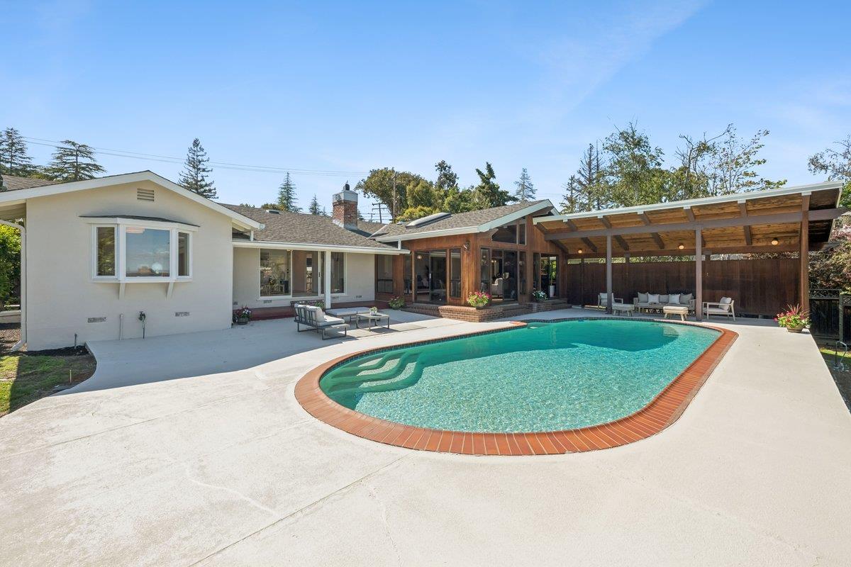 622 Terrace Road San Carlos, CA 94070 - Photo 63 of 83 a view of a white house with a swimming pool and a yard