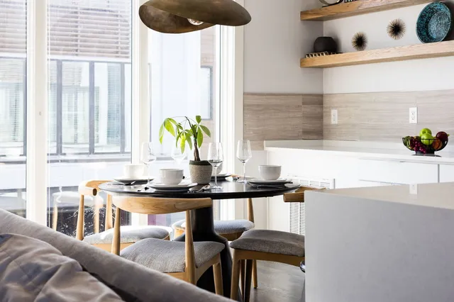 a kitchen with granite countertop a sink a stove and a table