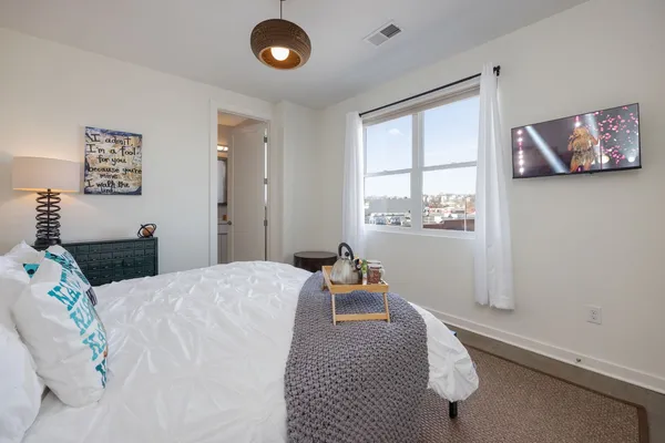 a bedroom with a bed and window
