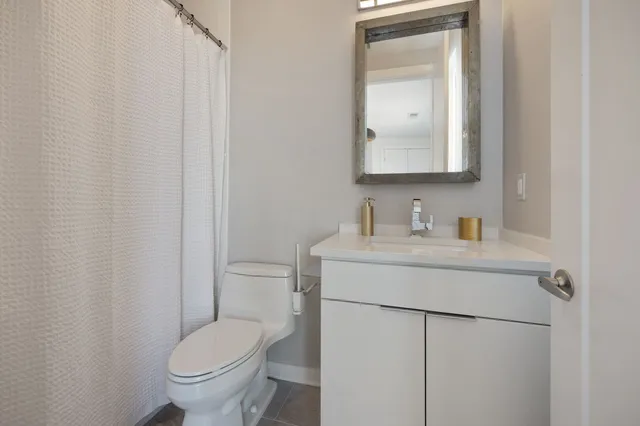 a bedroom with bed and a large window