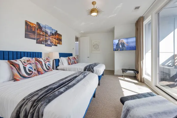 a bedroom with two beds and painting on the wall