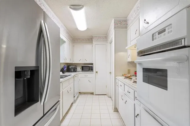a kitchen with cabinets and stainless steel appliances