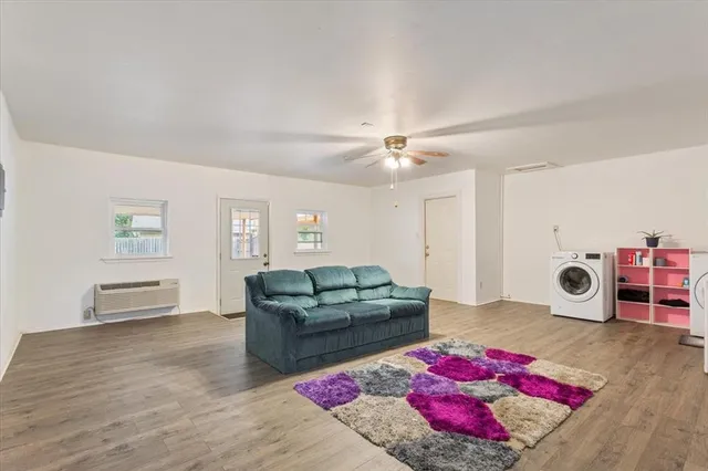 a living room with furniture and wooden floor