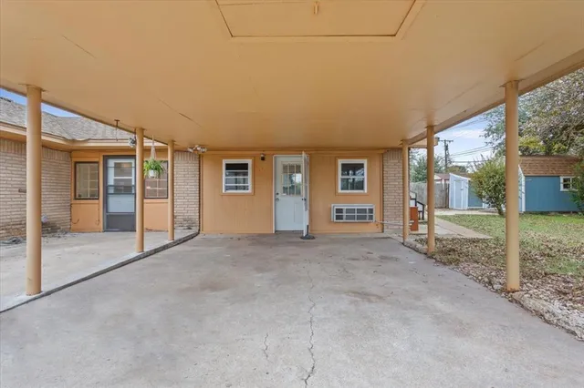 a view of an empty room with floor to ceiling windows
