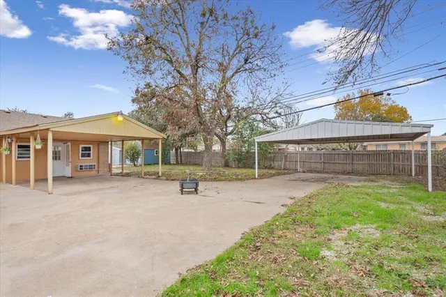 a view of a house with a yard and tree s