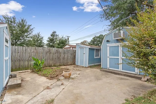 a backyard of a house with plants and trees