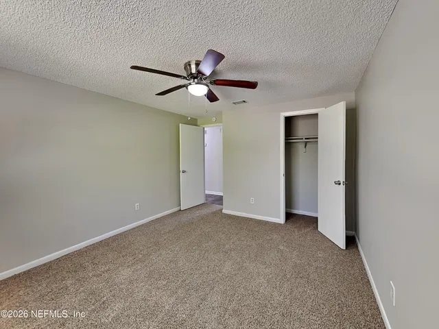 a view of a big room with carpet