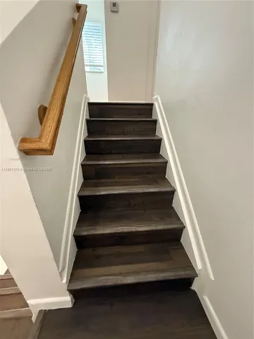 a bathroom with a granite countertop toilet sink and mirror