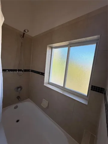 a room with a sink and a mirror