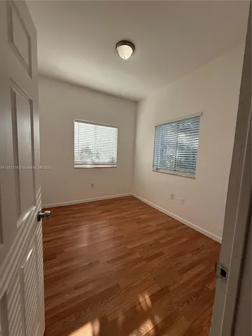 a bathroom with a toilet sink vanity and mirror