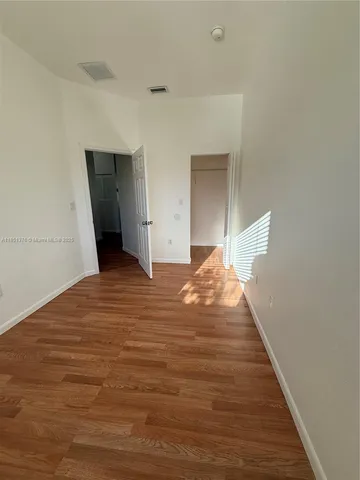 a view of a room with wooden floor