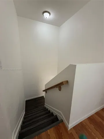 a white toilet sitting in a bathroom next to a sink