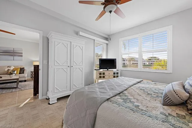 a bedroom with a bed and a television