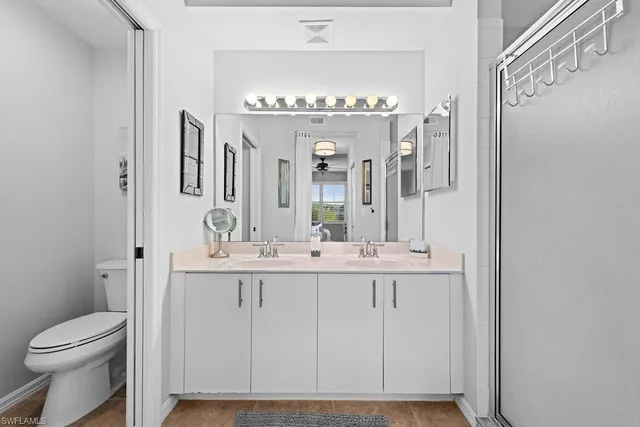 a bathroom with a sink a toilet and a mirror