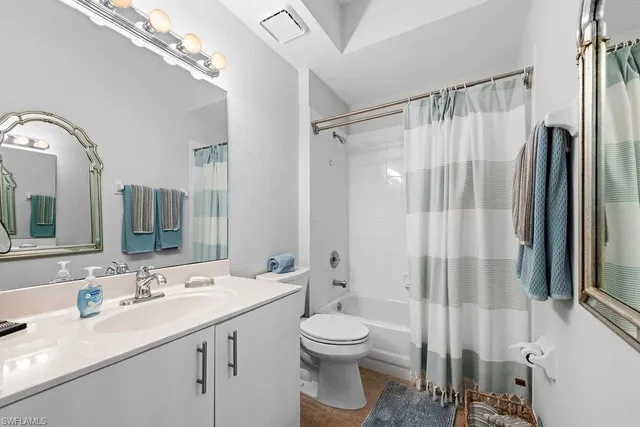 a bathroom with a double vanity sink toilet and shower