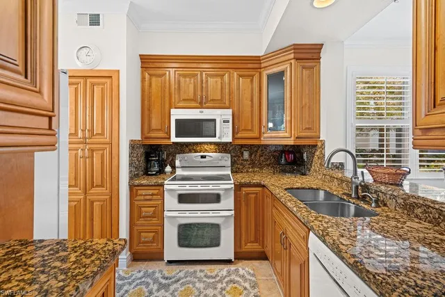 a kitchen with a stove a sink and a microwave