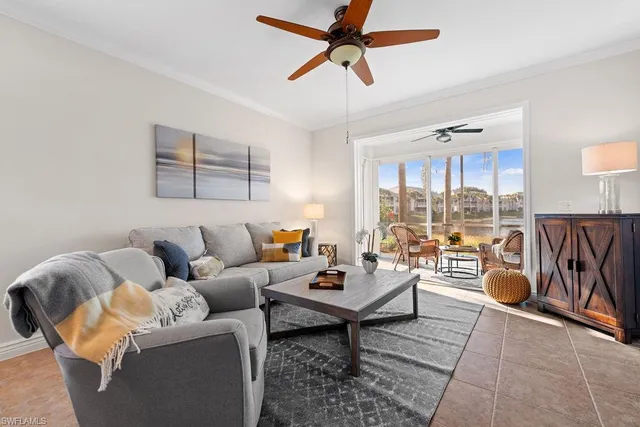 a living room with furniture a rug and a large window