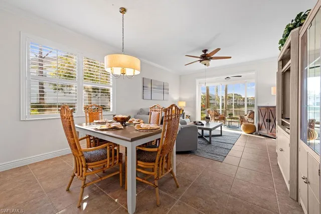 a dining room with furniture a chandelier and a rug