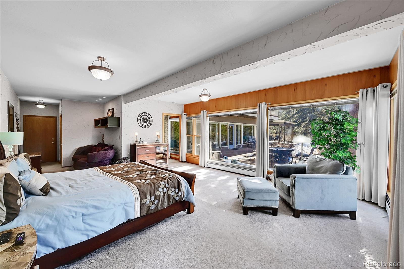31453 Upper Bear Creek Road Evergreen, CO 80439 - Photo 12 of 22 a bedroom with bed couch and large window