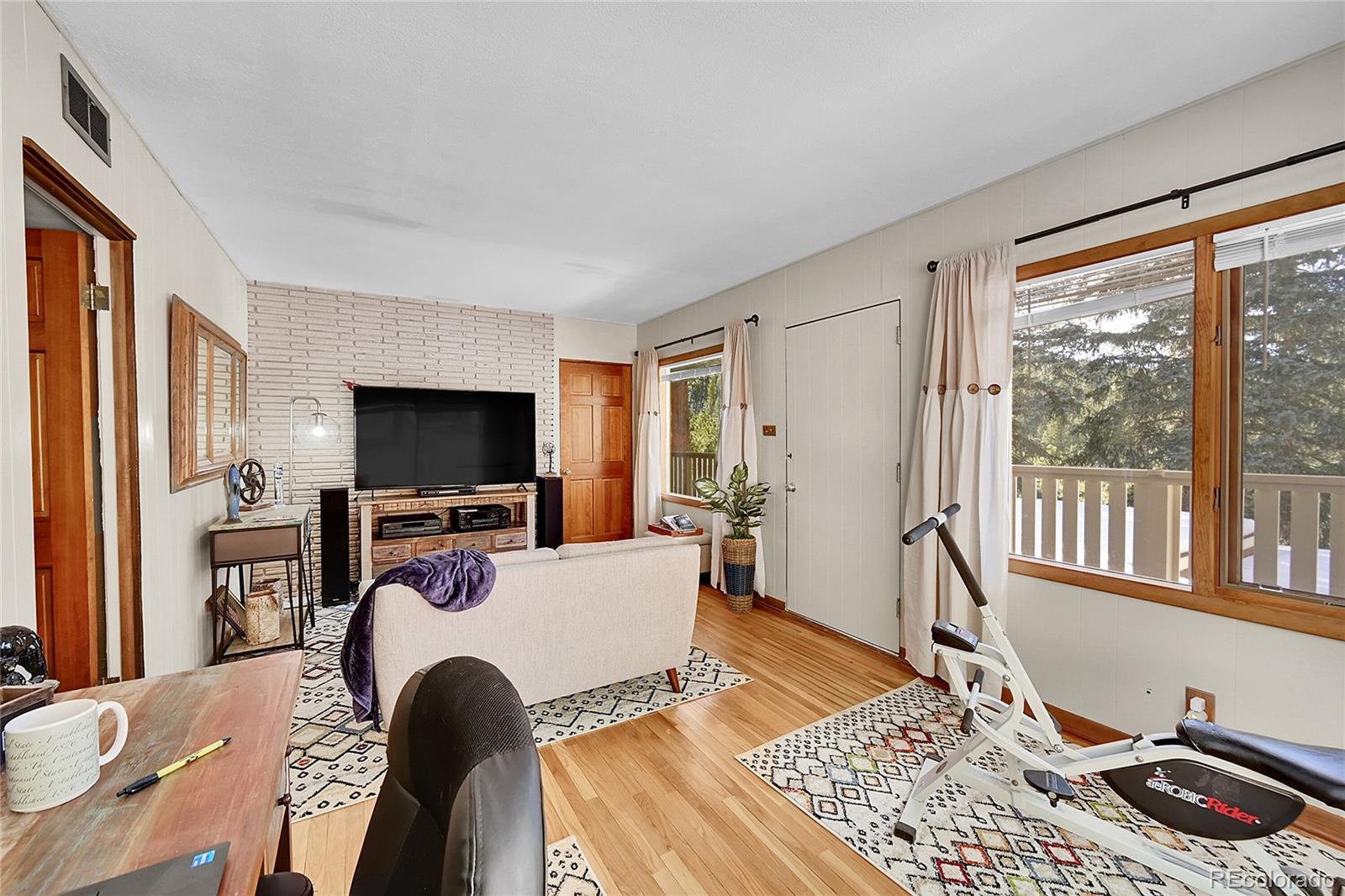 31453 Upper Bear Creek Road Evergreen, CO 80439 - Photo 19 of 22 a living room with furniture and a flat screen tv