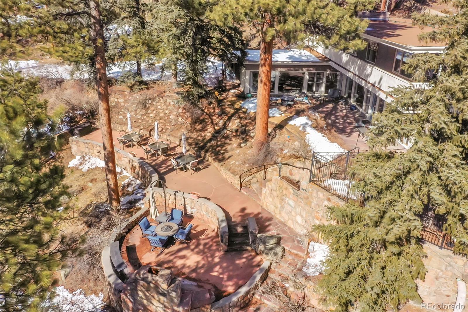 31453 Upper Bear Creek Road Evergreen, CO 80439 - Photo 20 of 22 a backyard of a house with large trees