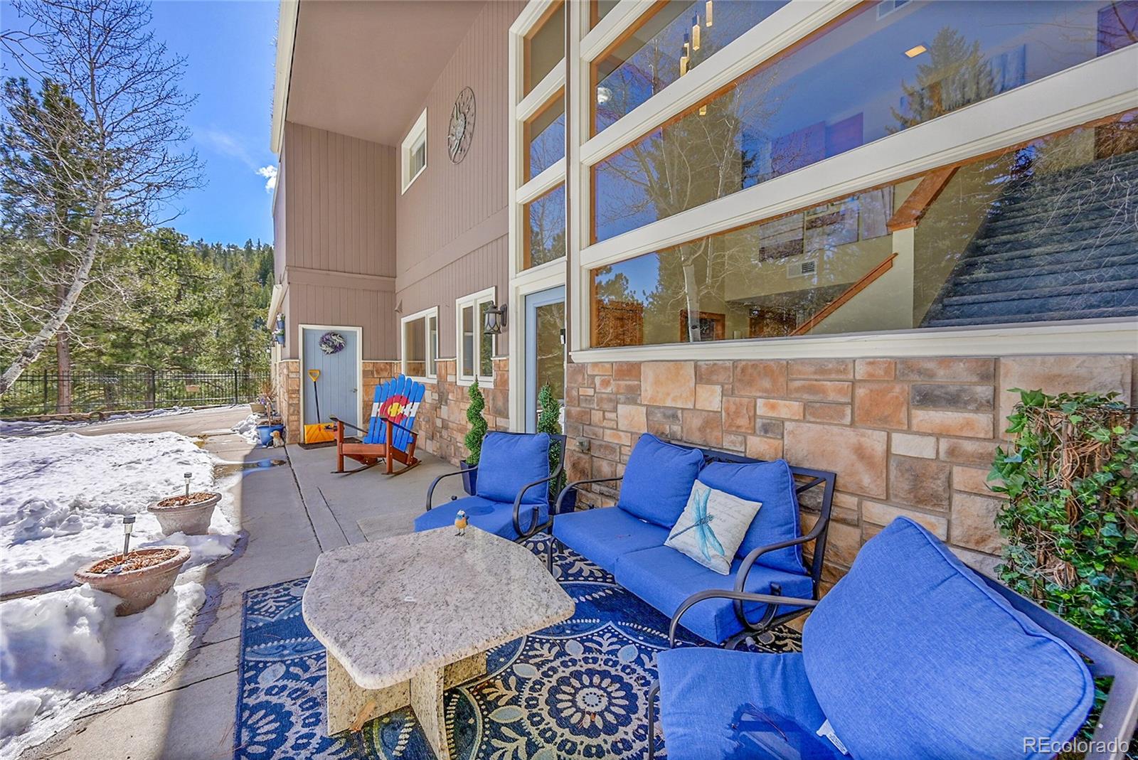 31453 Upper Bear Creek Road Evergreen, CO 80439 - Photo 4 of 22 a view of outdoor seating space with furniture and garden
