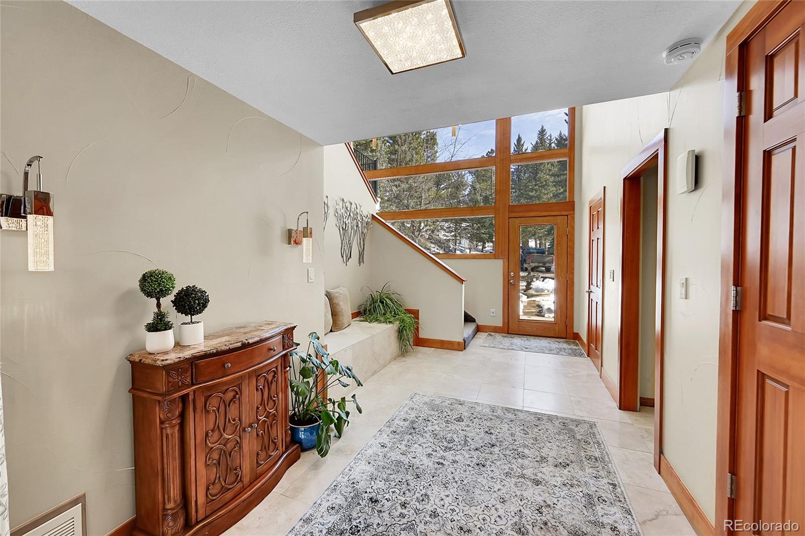 31453 Upper Bear Creek Road Evergreen, CO 80439 - Photo 5 of 22 a living room with furniture and a flat screen tv