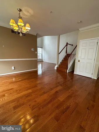 a view of entryway wooden floor and chandelier fan