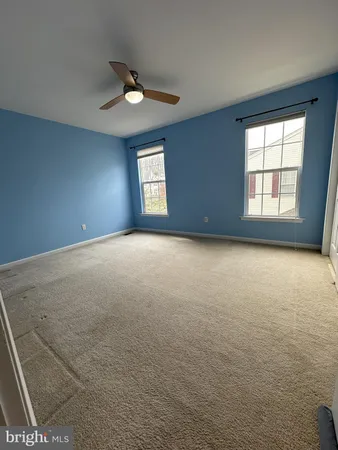 a view of an empty room with closet area