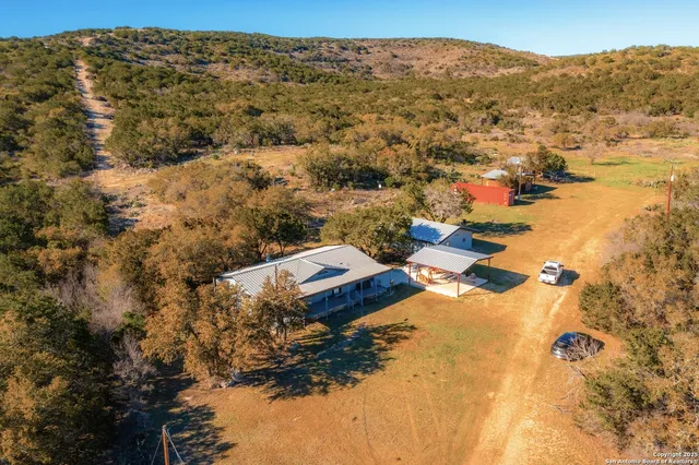 an aerial view of residential houses with outdoor space
