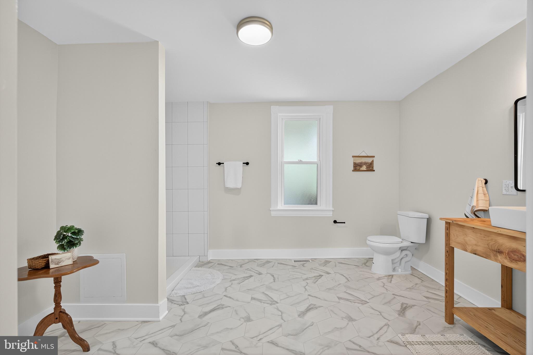 623 East Chestnut Street Lancaster, PA 17602 - Photo 27 of 58 a view of bathroom with a toilet a mirror and a shower