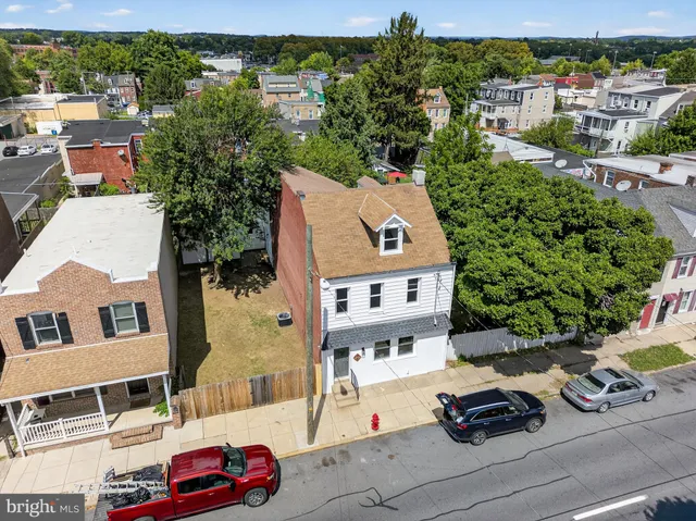 an aerial view of a house with car parked