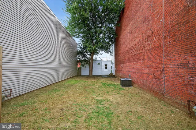 an aerial view of multiple houses with yard