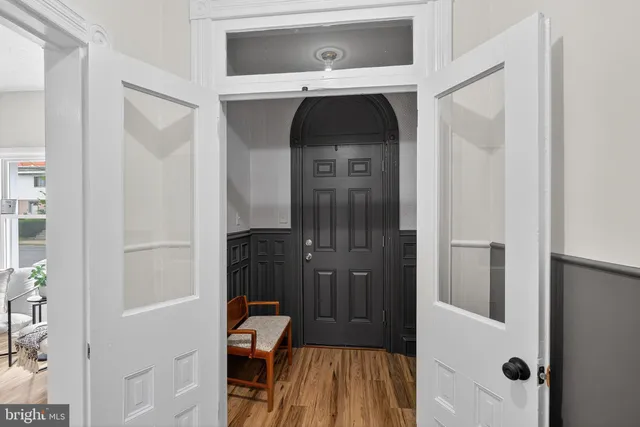 a view of a hallway with wooden floor and entryway